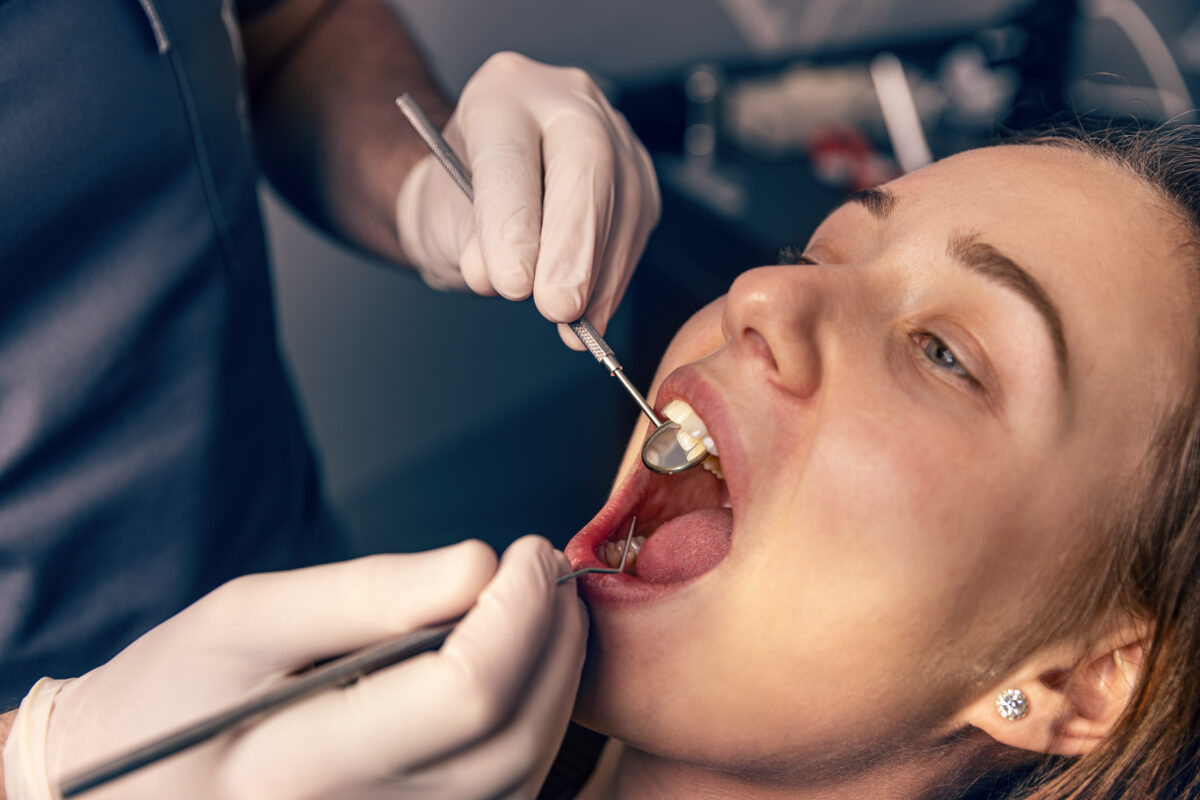 A dental patient getting examined for tongue tie and lip tie issues